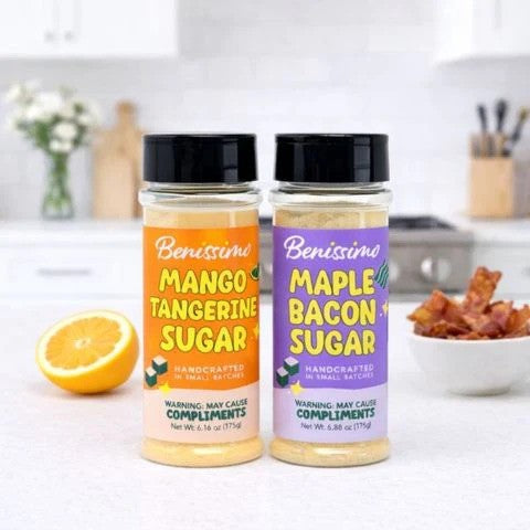 Two jars of Benissimo sugar products on a kitchen counter with ingredients in the background.